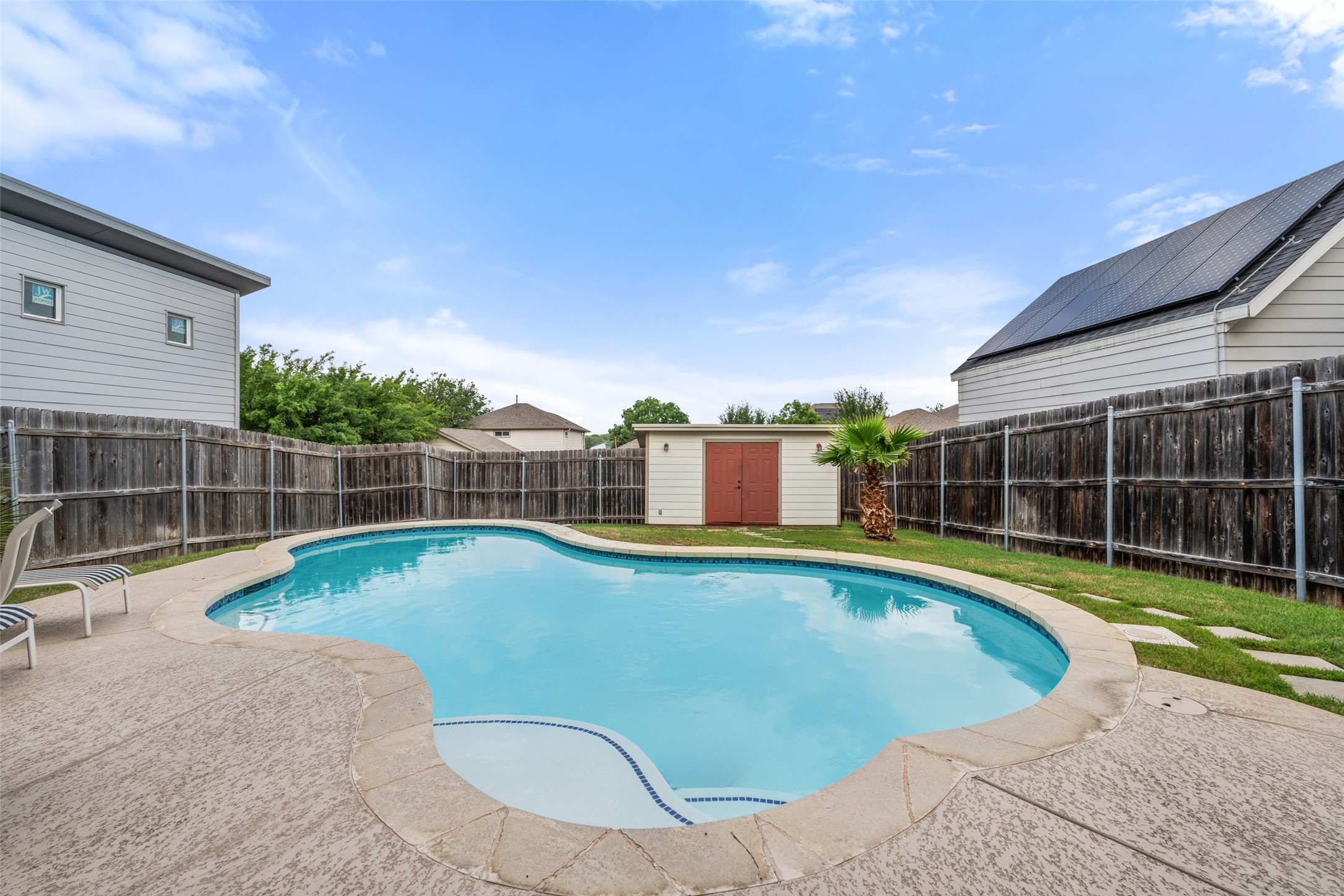 6006 Seville Drive Austin, TX 78724 - Photo 34 of 38 a view of a swimming pool with a yard and wooden fence