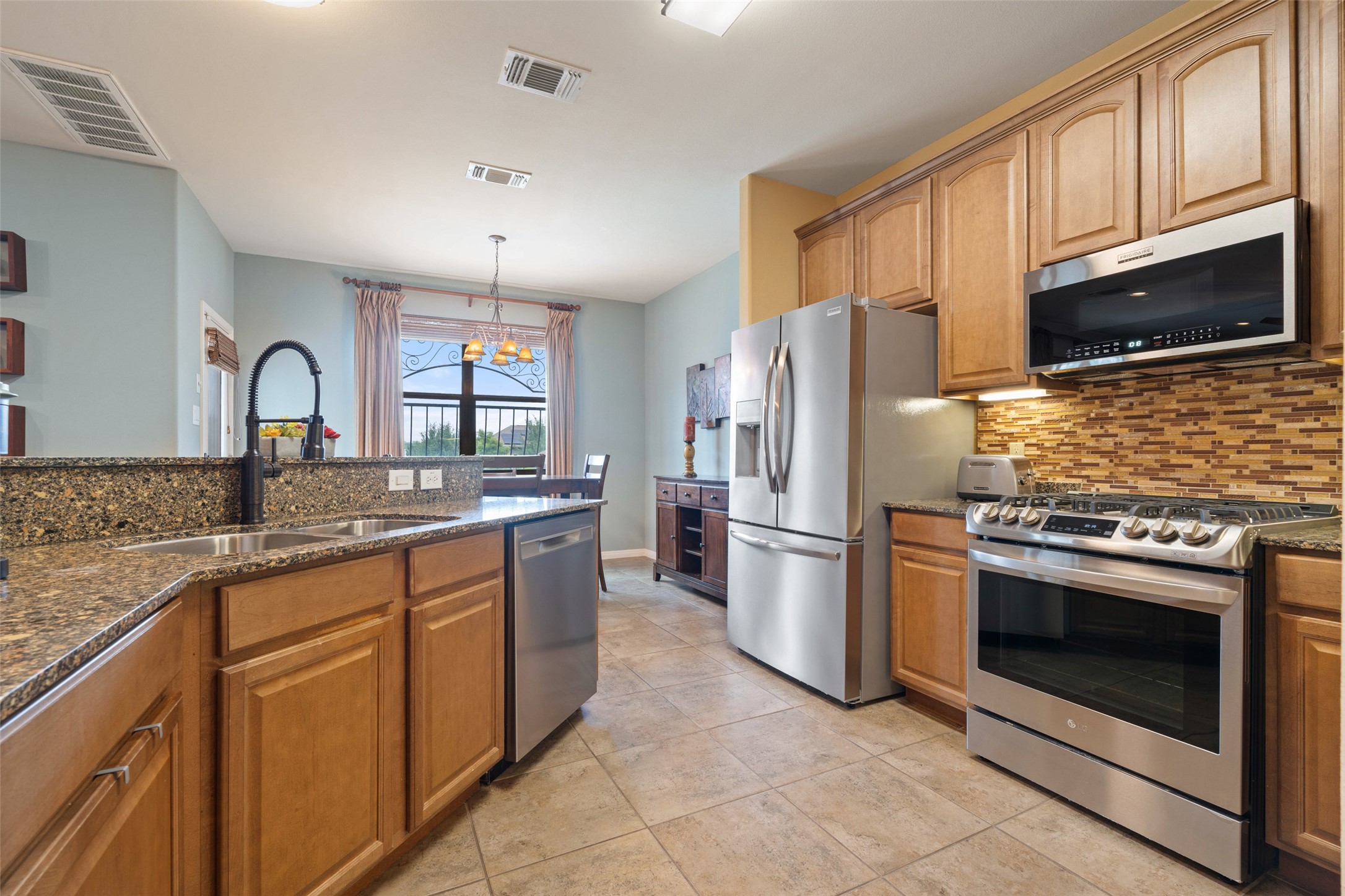 6006 Seville Drive Austin, TX 78724 - Photo 4 of 38 a kitchen with a sink stove and refrigerator