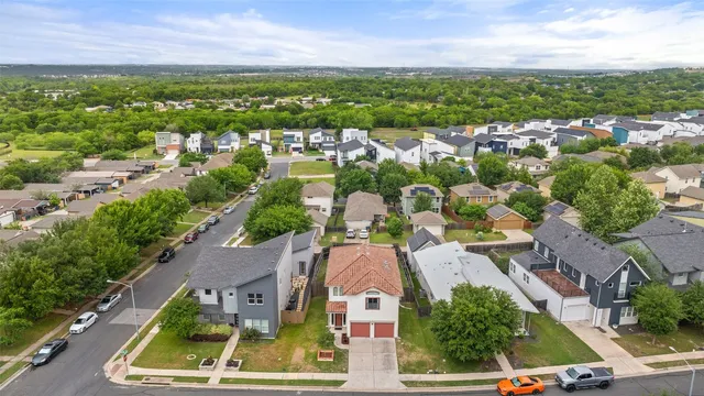 an aerial view of residential houses with outdoor space and street view