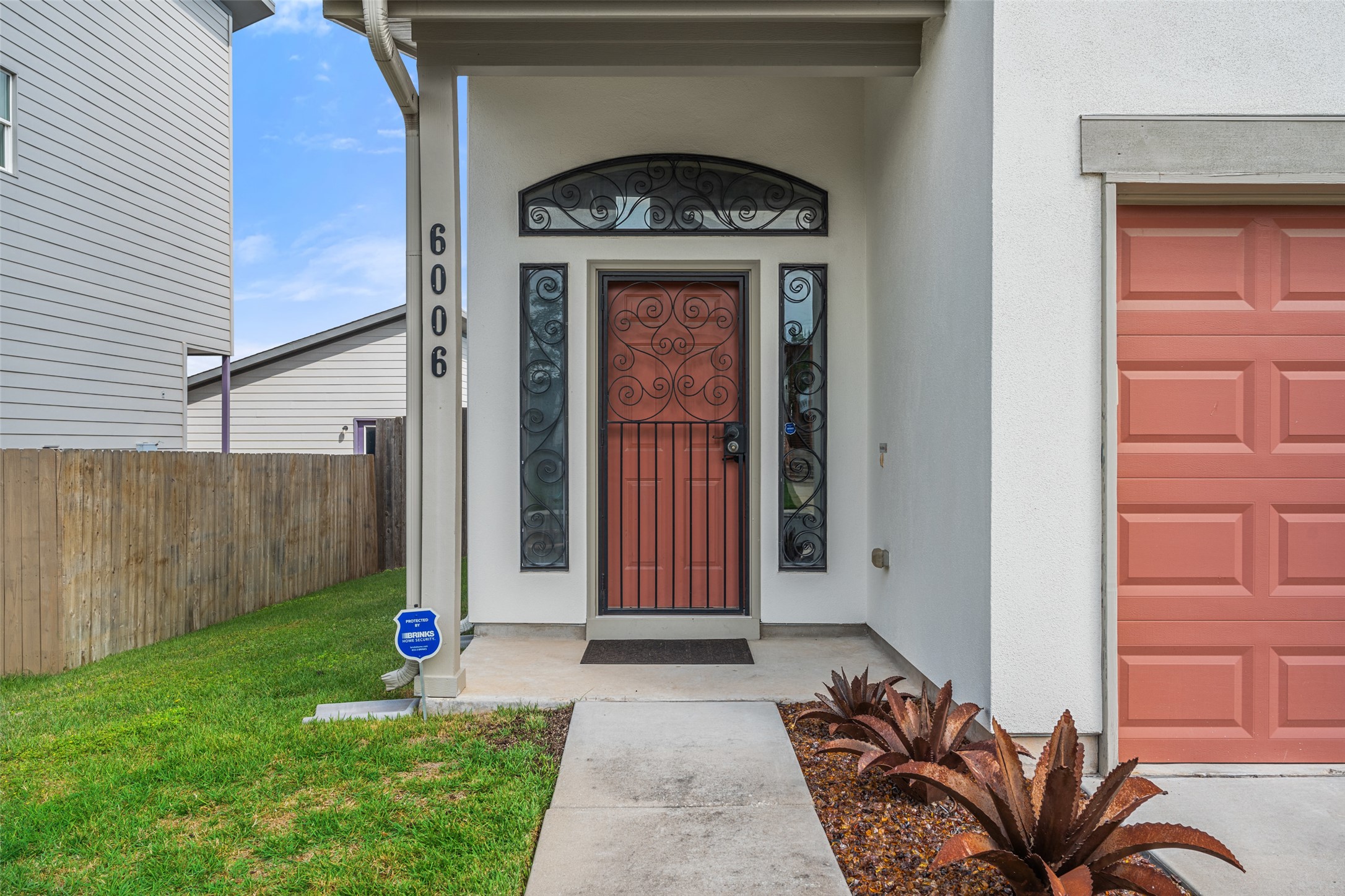 6006 Seville Drive Austin, TX 78724 - Photo 7 of 38 a front view of a house with garden