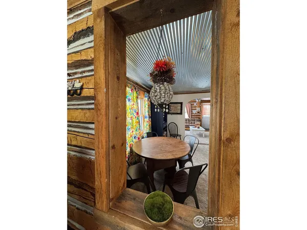 a dining room with furniture and a window