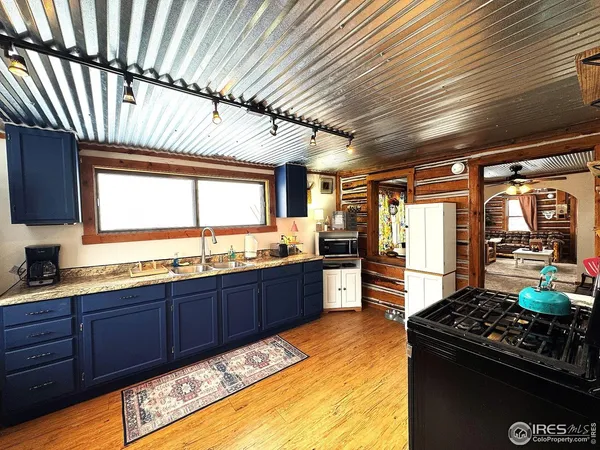 a open kitchen with stainless steel appliances granite countertop a sink stove and refrigerator