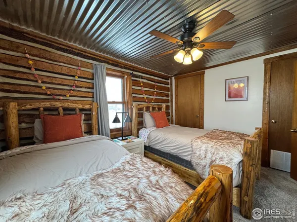 a bed sitting in a spacious bedroom next to a window