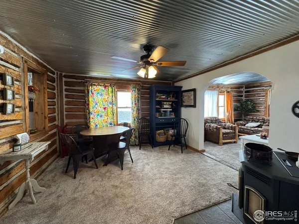 a view of a livingroom with furniture and a kitchen