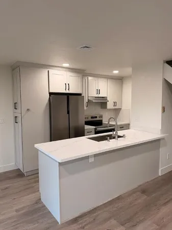 a kitchen with stainless steel appliances a refrigerator and a sink