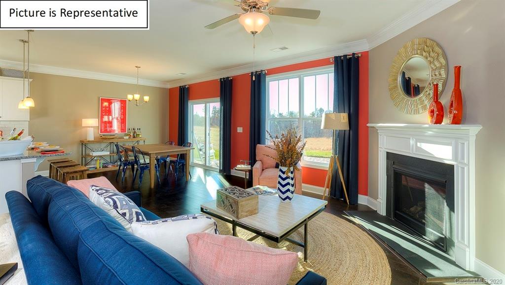 8007 Oakmere Road Waxhaw, NC 28173 - Photo 13 of 40 a living room with furniture a flat screen tv and a fireplace