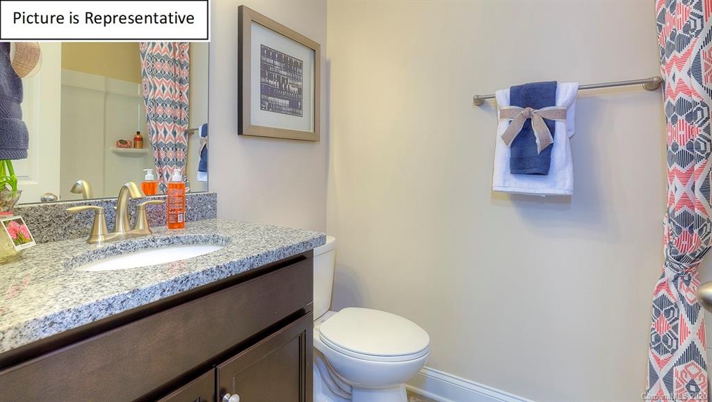 8007 Oakmere Road Waxhaw, NC 28173 - Photo 14 of 40 a bathroom with a granite countertop sink and a mirror