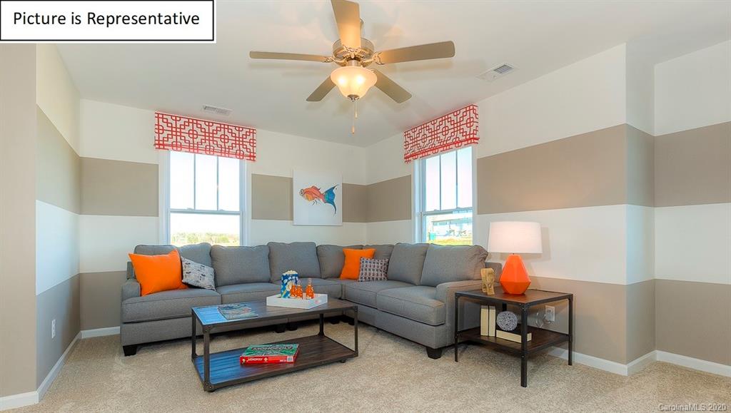 8007 Oakmere Road Waxhaw, NC 28173 - Photo 17 of 40 a living room with furniture and a chandelier