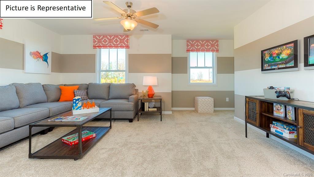 8007 Oakmere Road Waxhaw, NC 28173 - Photo 18 of 40 a living room with furniture and a book shelf