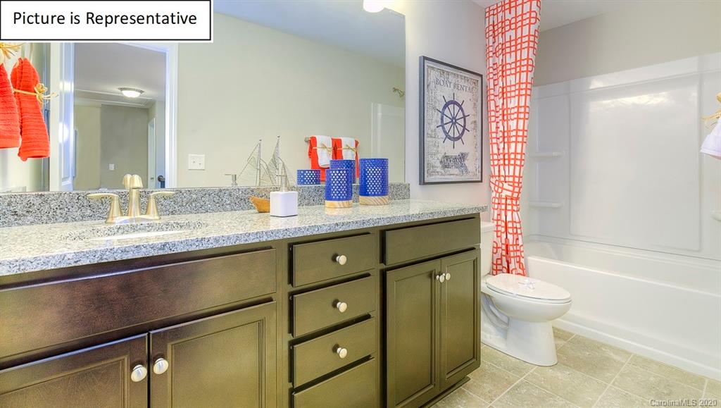 8007 Oakmere Road Waxhaw, NC 28173 - Photo 19 of 40 a bathroom with a granite countertop sink mirror vanity and toilet