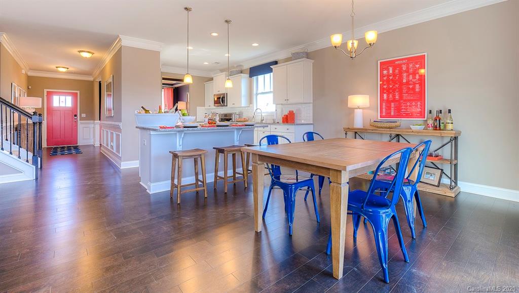 8007 Oakmere Road Waxhaw, NC 28173 - Photo 7 of 40 a dining room with stainless steel appliances kitchen island granite countertop wooden floor a dining table and chairs