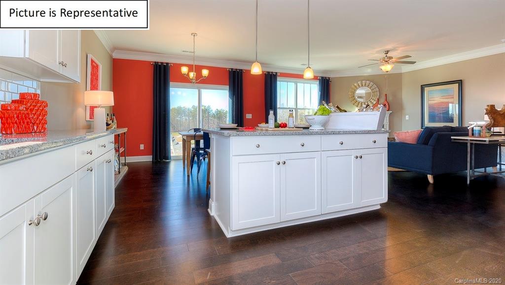 8007 Oakmere Road Waxhaw, NC 28173 - Photo 9 of 40 a kitchen with stainless steel appliances kitchen island granite countertop a refrigerator a sink dishwasher a dining table and chairs with wooden floor