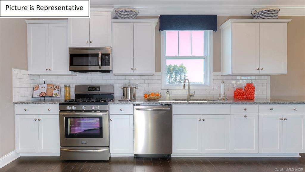 8007 Oakmere Road Waxhaw, NC 28173 - Photo 10 of 40 a kitchen with stainless steel appliances granite countertop a sink and a microwave