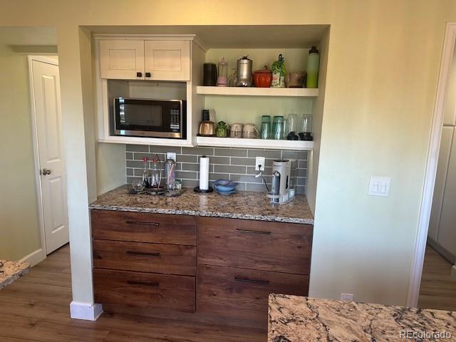 8865 Thunderbird Road Parker, CO 80134 - Photo 11 of 33 a kitchen with a stove and a microwave