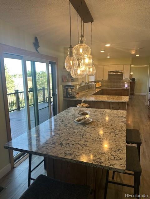 8865 Thunderbird Road Parker, CO 80134 - Photo 12 of 33 a view of a dining room with furniture wooden floor and chandelier