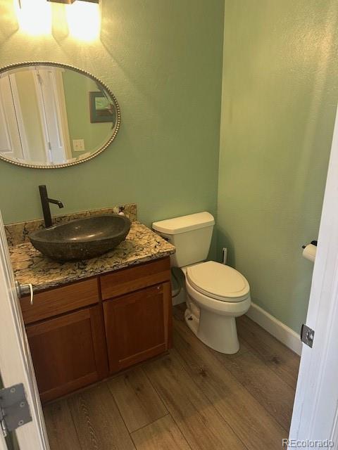 8865 Thunderbird Road Parker, CO 80134 - Photo 15 of 33 a bathroom with a granite countertop toilet and a sink
