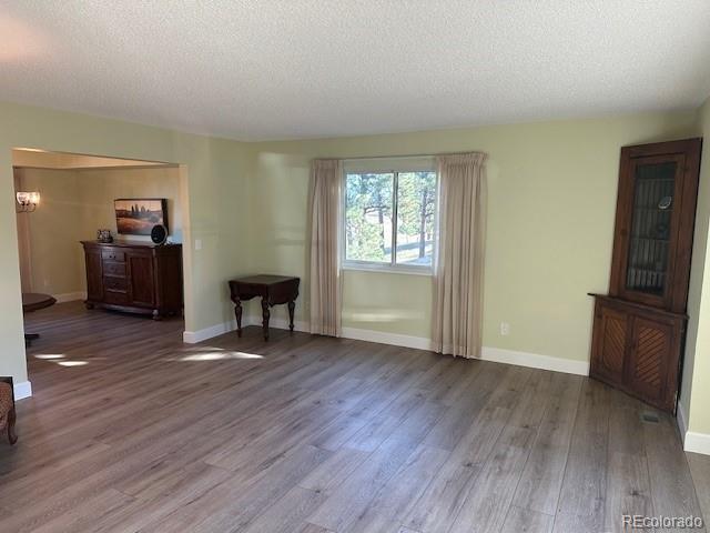 8865 Thunderbird Road Parker, CO 80134 - Photo 18 of 33 a view of a livingroom with wooden floor and furniture