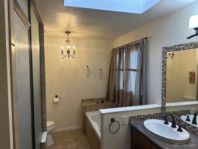 8865 Thunderbird Road Parker, CO 80134 - Photo 23 of 33 a bathroom with a granite countertop sink a toilet and shower