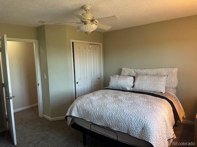 8865 Thunderbird Road Parker, CO 80134 - Photo 28 of 33 a spacious bedroom with a bed and a chandelier
