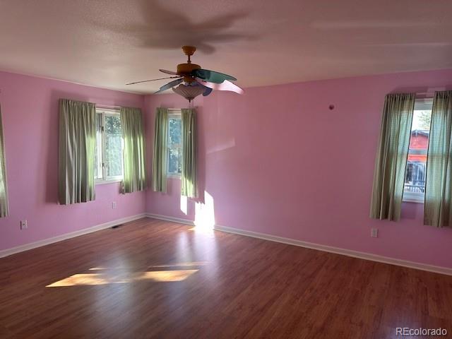 8865 Thunderbird Road Parker, CO 80134 - Photo 32 of 33 a view of a livingroom with hardwood floor and a ceiling fan