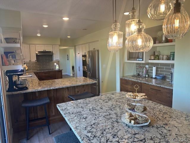 8865 Thunderbird Road Parker, CO 80134 - Photo 10 of 33 a kitchen with a table and chairs in it