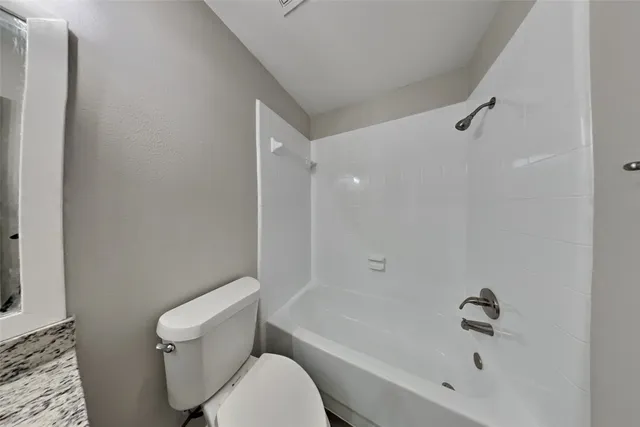 a bathroom with a bathtub and a toilet