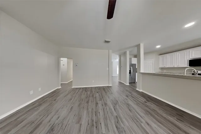 a view of kitchen with refrigerator and window