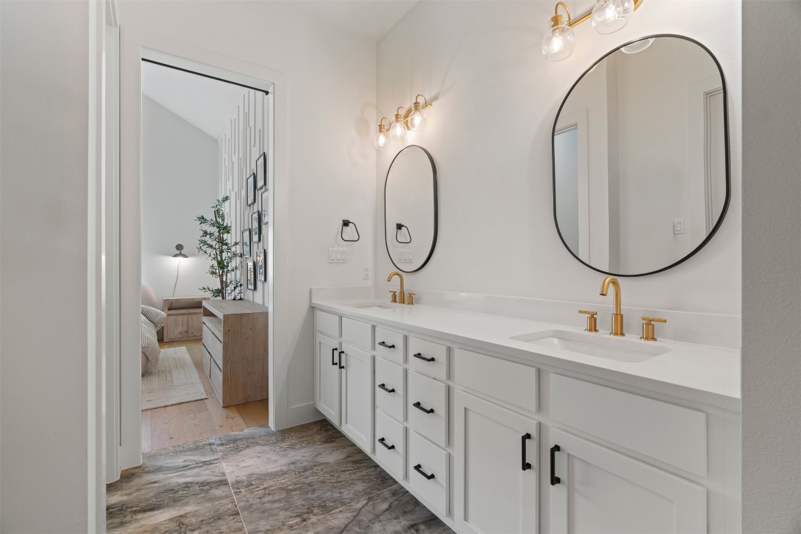 330 Kendall Road Spicewood, TX 78669 - Photo 11 of 32 a bathroom with double vanity sink and a mirror