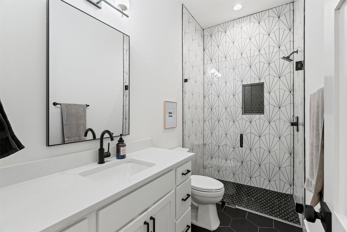 330 Kendall Road Spicewood, TX 78669 - Photo 13 of 32 a bathroom with a sink toilet and shower