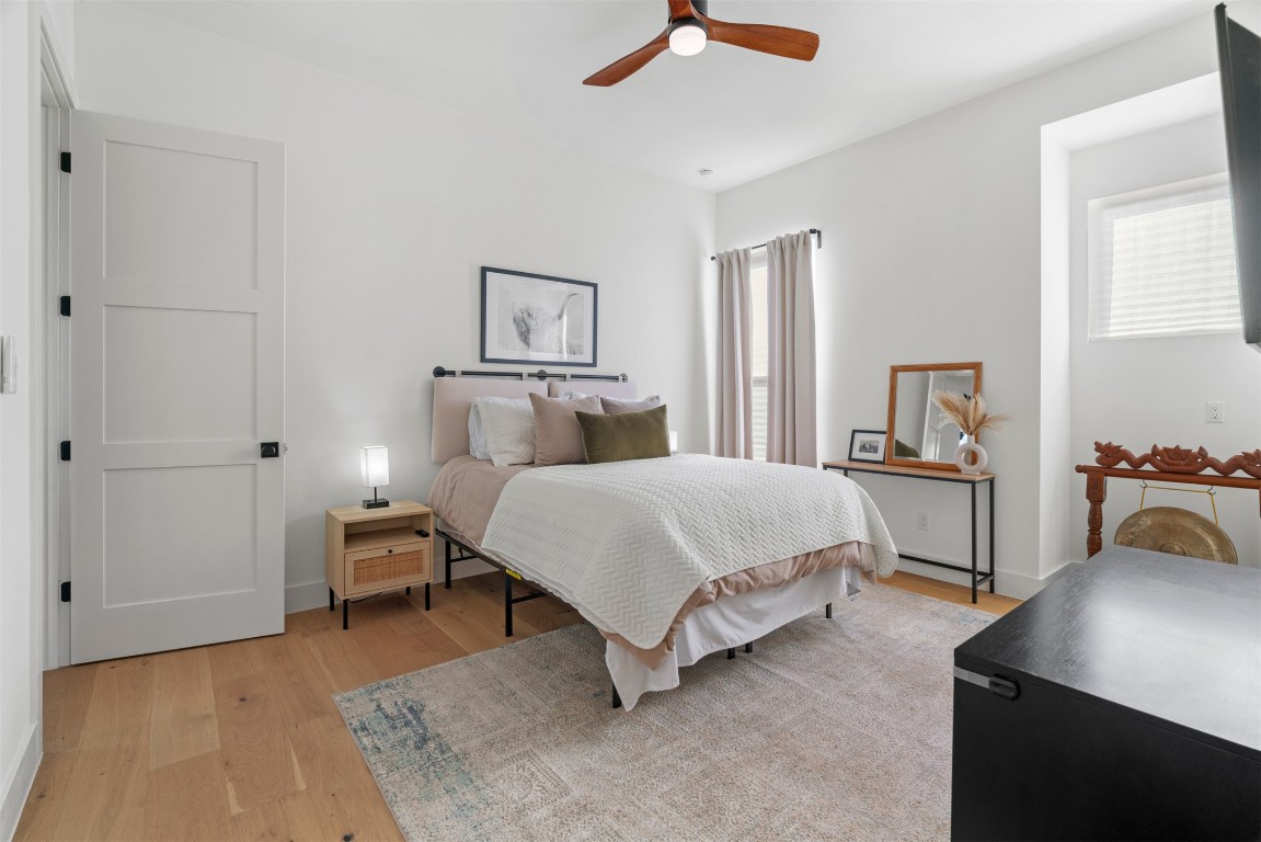 330 Kendall Road Spicewood, TX 78669 - Photo 19 of 32 a bedroom with a bed and a table in it