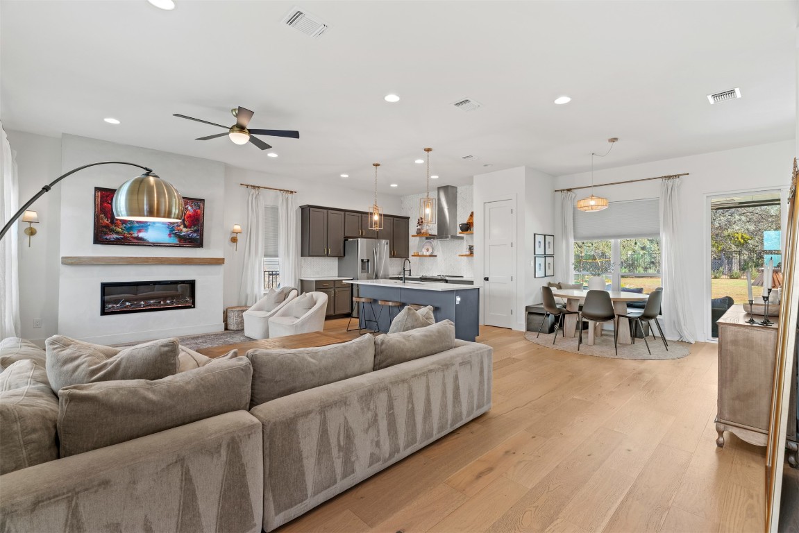 330 Kendall Road Spicewood, TX 78669 - Photo 2 of 32 a living room with fireplace furniture and a wooden floor
