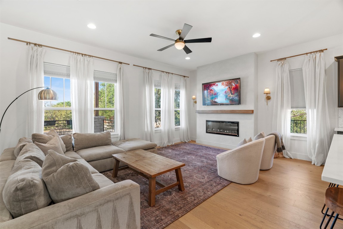 330 Kendall Road Spicewood, TX 78669 - Photo 3 of 32 a living room with furniture a flat screen tv and a fireplace