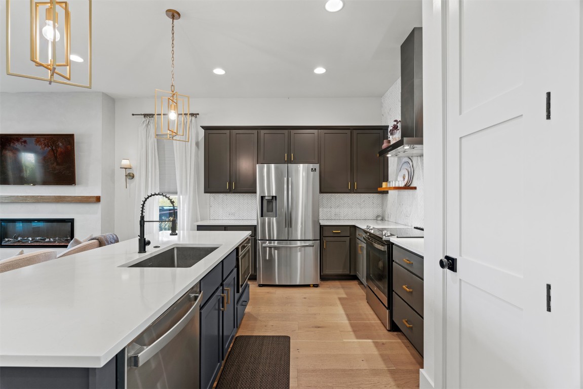 330 Kendall Road Spicewood, TX 78669 - Photo 5 of 32 a kitchen with a sink stove and refrigerator