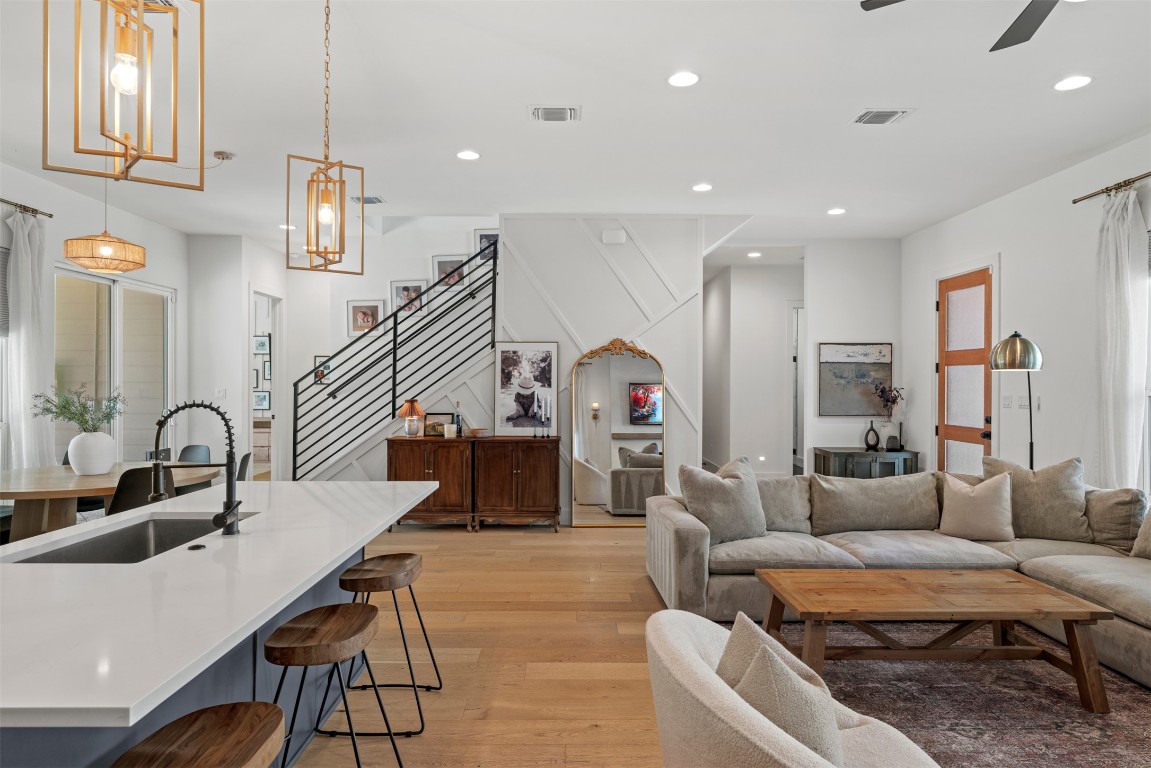 330 Kendall Road Spicewood, TX 78669 - Photo 6 of 32 a living room with furniture kitchen view and a chandelier