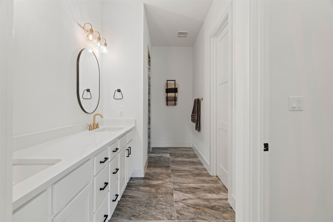 330 Kendall Road Spicewood, TX 78669 - Photo 9 of 32 a bathroom with a double vanity sink and mirror