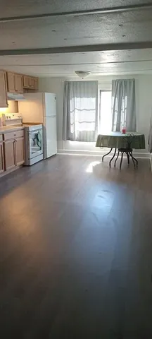a view of livingroom with furniture wooden floor and windows