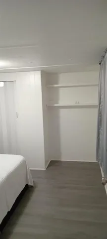 a bedroom with a bed and cabinets