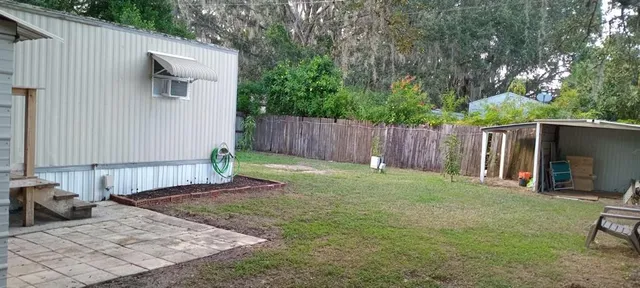a view of a backyard with furniture