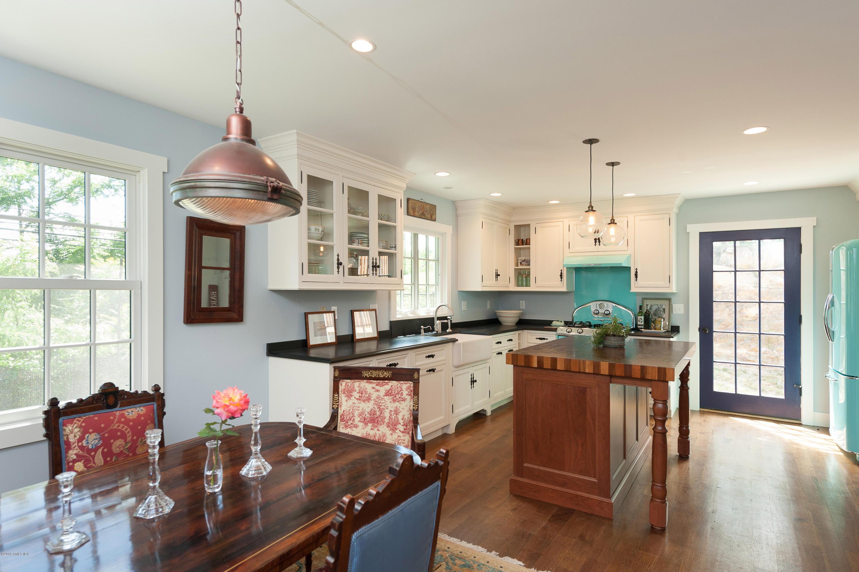 2 Cary Road Riverside, CT 06878 - Photo 1 of 24 a kitchen with stainless steel appliances granite countertop a stove top oven a dining table and chairs with wooden floor
