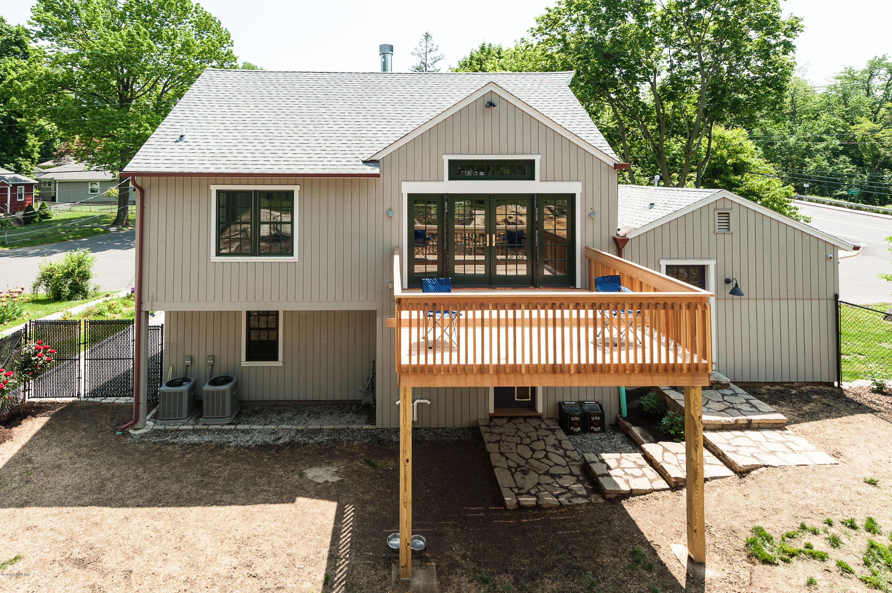 2 Cary Road Riverside, CT 06878 - Photo 4 of 24 a view of a house with a small yard and a wooden deck