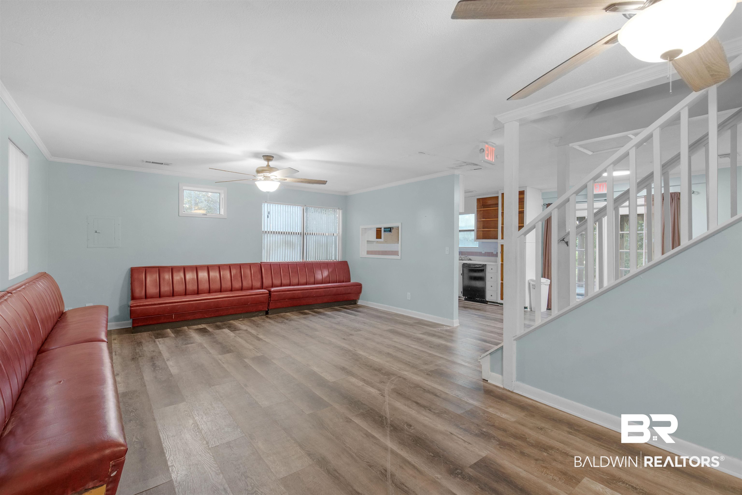 28290 Canal Road Orange Beach, AL 36561 - Photo 5 of 32 Living area featuring baseboards, ornamental molding, a ceiling fan, wine cooler, and wood finished floors
