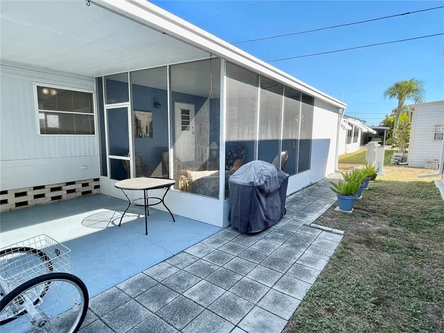 a living room with furniture a rug and white walls