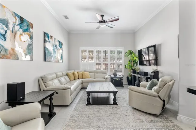 a kitchen with stainless steel appliances a dining table chairs refrigerator and sink