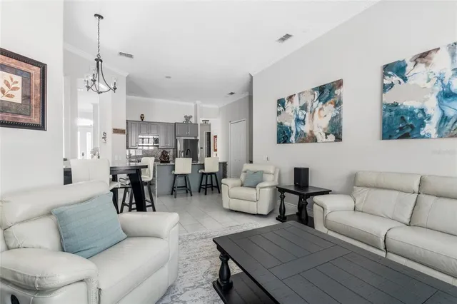 a kitchen with a refrigerator sink and white cabinets