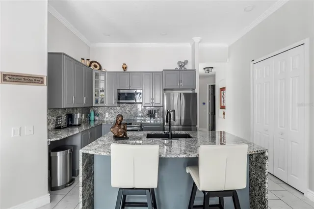 a kitchen with granite countertop a sink and cabinets