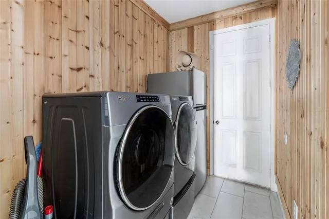 a bedroom with a bed and painting on the wall