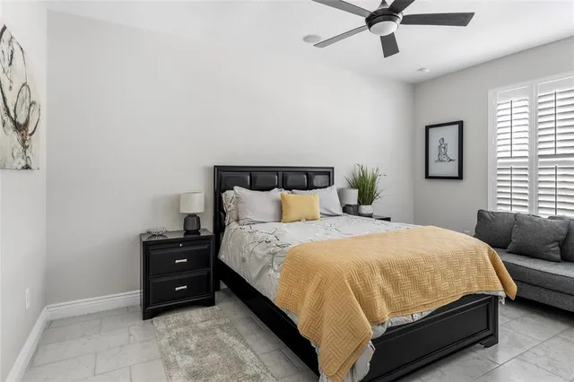 a bathroom with a granite countertop sink a toilet and a mirror