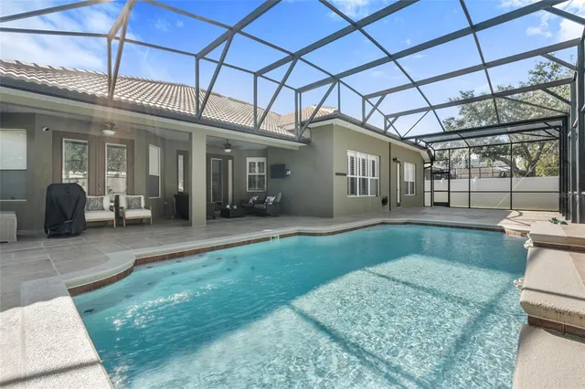 an aerial view of a house with outdoor space and trees all around