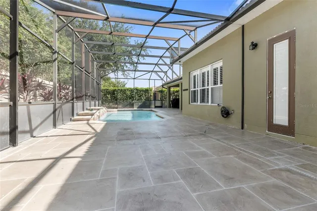 an aerial view of a house with a yard and lake view
