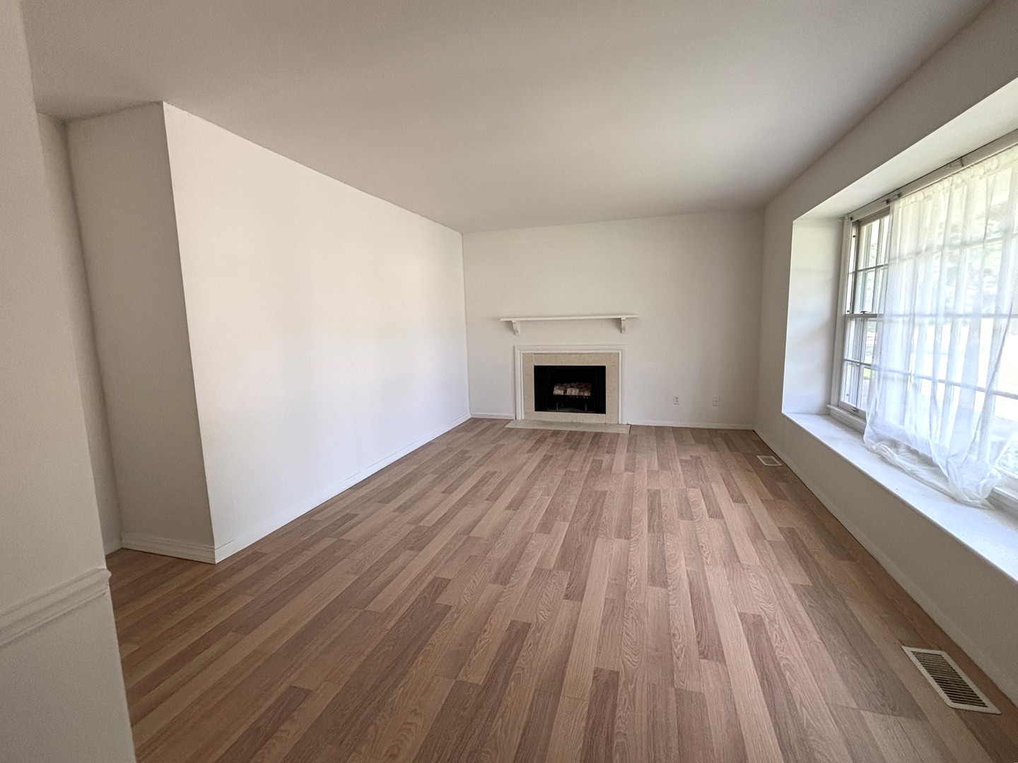 22 Guilford Road Montgomery, IL 60538 - Photo 3 of 14 a view of empty room with wooden floor and fireplace